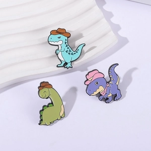 Three cute cartoon dinosaur enamel pins wearing cowboy hats for backpacks and accessories