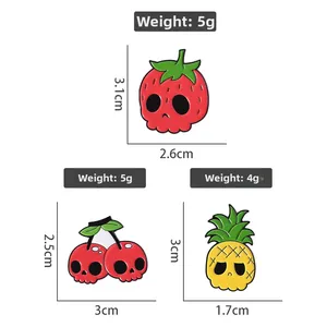 Detail view of strawberry cherry and pineapple skull enamel pins with size measurements