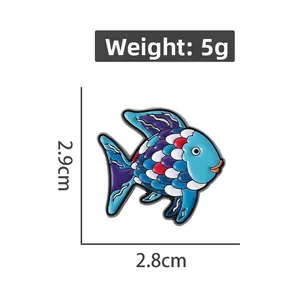 Detail view of colorful fish enamel pin showing dimensions 2.9cm x 2.8cm and 5g weight