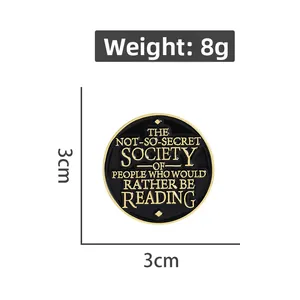 Macro detail of 3cm round enamel reading pin with motivational text and gold accents