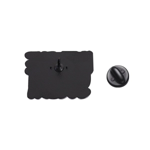 Detail view of the black metal brooch back with secure rubber pin clutch on white background