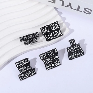Set of five black enamel brooches with Spanish inspirational quotes and metal pins