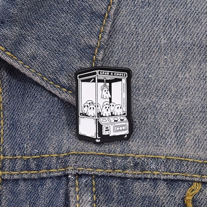 Détail du pin's émaillé Grab a Ghost avec fantômes mignons sur tissu en jean bleu