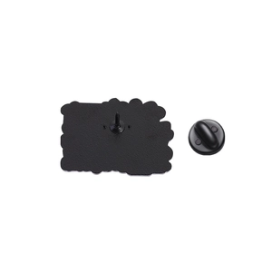 Macro view of matte black metal brooch back with secure pin and rubber butterfly clutch