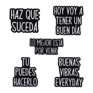 5-piece set of minimalist black and white enamel pins with Spanish inspirational phrases