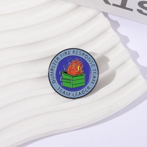 Round Dumpster Fire Response Team enamel badge pin displayed on white wavy texture