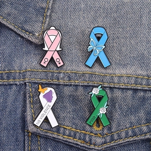 Macro view of colorful enamel ribbon brooches with butterfly and flower on denim jacket