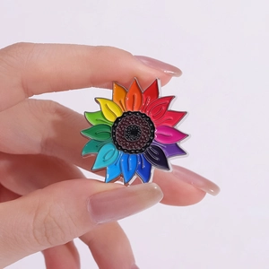 Vue macro d'une broche tournesol en émail arc-en-ciel avec des pétales dégradés colorés