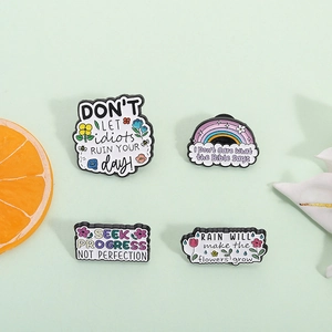 Pastel enamel pins set with rainbow and bee designs featuring inspirational English quotes
