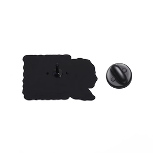 Detail showing the matte black metal pin back and rubber clutch of the philosopher brooch