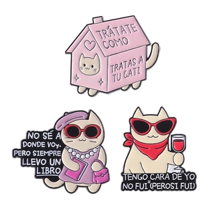 Three-piece cartoon cat enamel pin set featuring pink house and cats with Spanish text