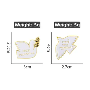 Detail view of white dove enamel pins with Free Palestine text and wheat branch