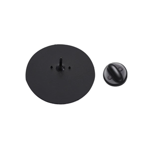 Close-up of black round metal badge back with secure pin and rubber clutch attachment