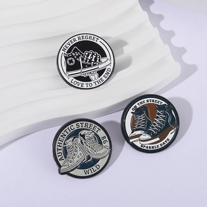 Set of three vintage round enamel canvas shoe badges with retro inscriptions on white stands