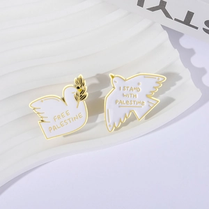 Set of two white and gold dove enamel pins with Free Palestine olive branch motifs