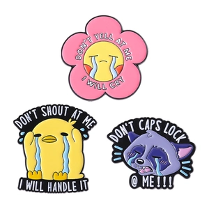 Cartoon enamel pins set with cute yellow duck and raccoon designs on white background
