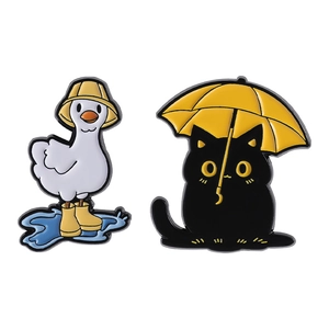 Cute enamel pin set featuring a white duck in rain boots and a black cat with an umbrella
