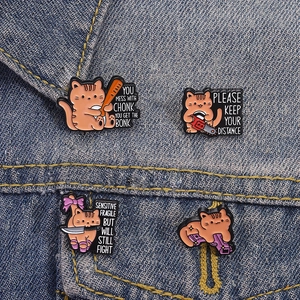 Funny orange cat enamel pins set of 4 with humorous slogans on denim background