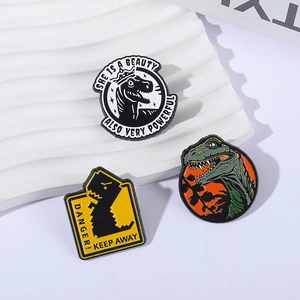 Three-piece dinosaur enamel pin set including T-Rex crown and warning sign designs