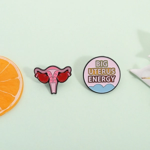 Empowering pink uterus enamel pins set with boxing gloves and Big Uterus Energy text