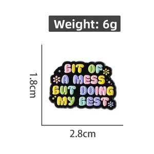 Detail shot of enamel quote pin measuring 2.8cm by 1.8cm weighing six grams total