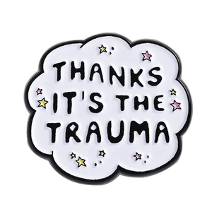 Cloud-shaped enamel pin with 'THANKS IT'S THE TRAUMA' slogan and colorful stars