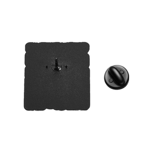 Detail of the black matte metal brooch back with rubber clutch and fixing pin