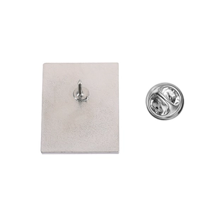 Detail view of silver metal brooch back with sandblasted texture and butterfly clasp closure