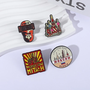 Set of four Russian Kremlin and Matryoshka doll enamel pins on a textured display