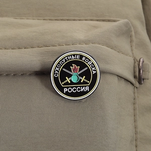 Detailed close-up of Russian Ground Forces enamel military badge pinned on khaki fabric