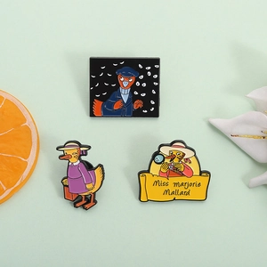 Three-piece duck detective enamel pin set featuring cartoon characters on green surface