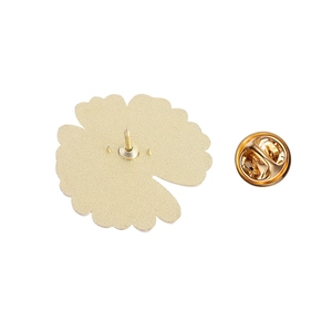 Macro shot of gold plated floral brooch back with butterfly clutch and matte metal texture