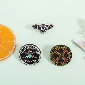 Russian military style enamel pins featuring bat and Wagner badges on a green background