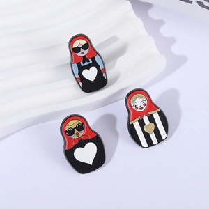 Three Matryoshka doll enamel pins with modern sunglasses and heart patterns