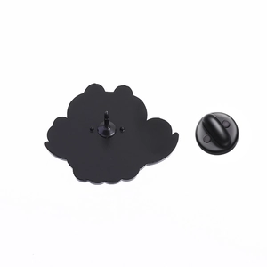 Detail view of the black enamel pin back with standard needle and rubber clasp closure
