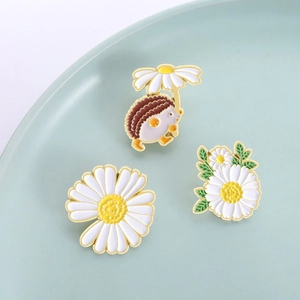 Three-piece daisy hedgehog enamel pin set with white petals and gold-plated edges