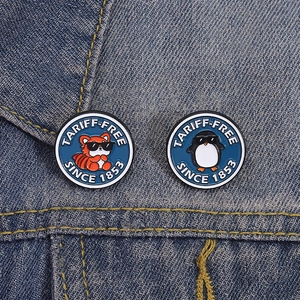 Cartoon enamel pins with tiger and penguin wearing sunglasses on denim jacket background