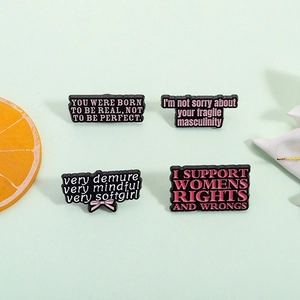 Set of 4 black enamel brooches with pink feminist slogans and motivational quotes