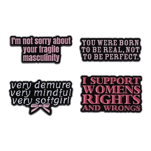 Set of four feminist enamel pins with social slogans on white background