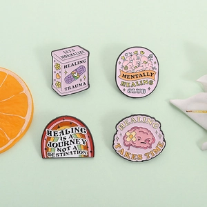 Set of 4 mental health enamel pins with rainbow and healing quotes on green background