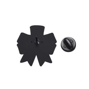 Detail view of black bow brooch metal back with single pin and secure rubber clutch