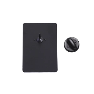Detail of a matte black rectangular metal badge back with a secure butterfly clutch pin