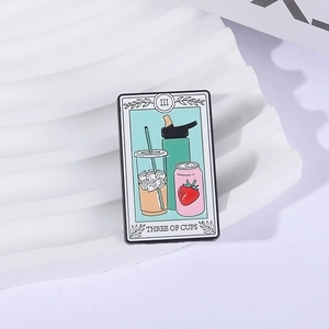 Three of Cups tarot enamel pin featuring modern juice drinks in a black metal frame