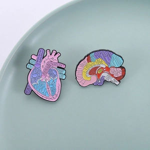 Anatomical heart and brain enamel pin set in ceramic plate for clothing decoration