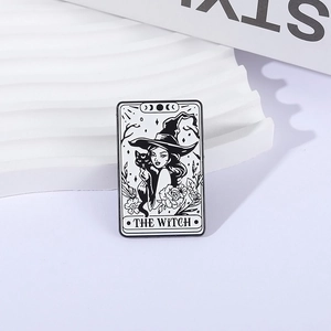 Tarot style enamel pin featuring black and white witch with black cat and rose design