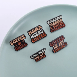 Five-piece vintage coffee enamel pin set with retro brown tones on a ceramic plate