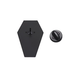 Detail view of the black matte metal pin back and securing butterfly clutch for badges