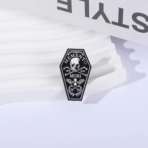 Gothic coffin enamel pin with Memento Mori skeleton design on white display stand