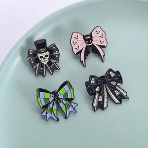 Set of four Halloween enamel pins featuring skull, ghost, and bat bowknot designs