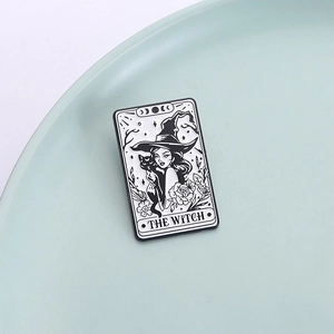 Tarot style black and white metal enamel pin featuring a witch with black cat and roses